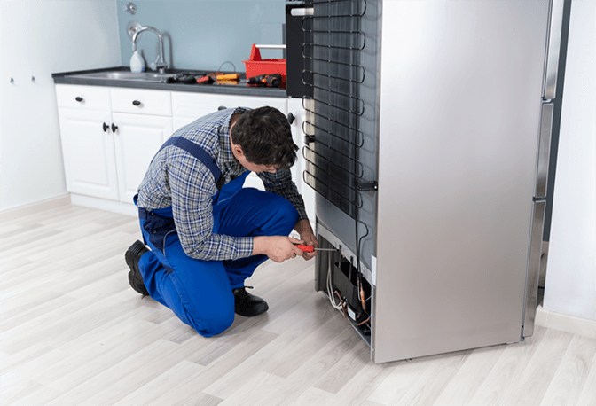 Certified Technician Repairing Fridge